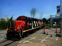 CN 4115 lets out some smoke as CN 500 crosses Bridge Street, nearly back at Pointe St-Charles Yard after a run to the port.