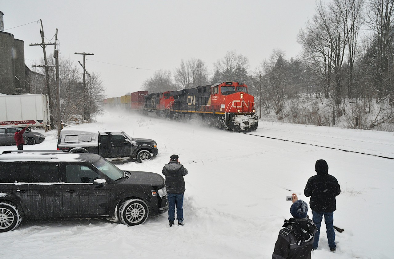 Snow?  Oh big deal. Hardy, or maybe crazy, fans are out in force with cameras after a good snow in order to catch some action on the CN.  The reward was CN 2259 and 8961 eastbound with #148, a stack train. Too chilly to hang around though. The location is that popular drive in spot next to the old mill in Copetown.