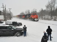  Snow?  Oh big deal. Hardy, or maybe crazy, fans are out in force with cameras after a good snow in order to catch some action on the CN.  The reward was CN 2259 and 8961 eastbound with #148, a stack train. Too chilly to hang around though. The location is that popular drive in spot next to the old mill in Copetown.