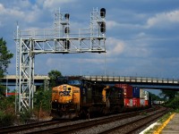 Getting rare these days, a pair of YN2 units leads CN 327 underneath a signal gantry at Dorval.