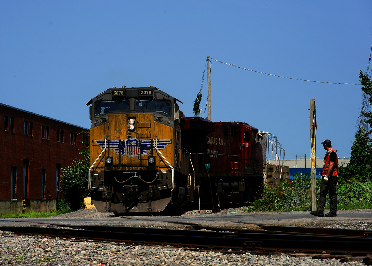 One of ten SD70ACe-T4 on lease to CPKC, UP 3078 is temporarily leading as it advances over a crossing just outside of Lachine IMS Yard. It is about to pick up rear DP CP 7025 before the power of CPKC 112 heads to St-Luc Yard.