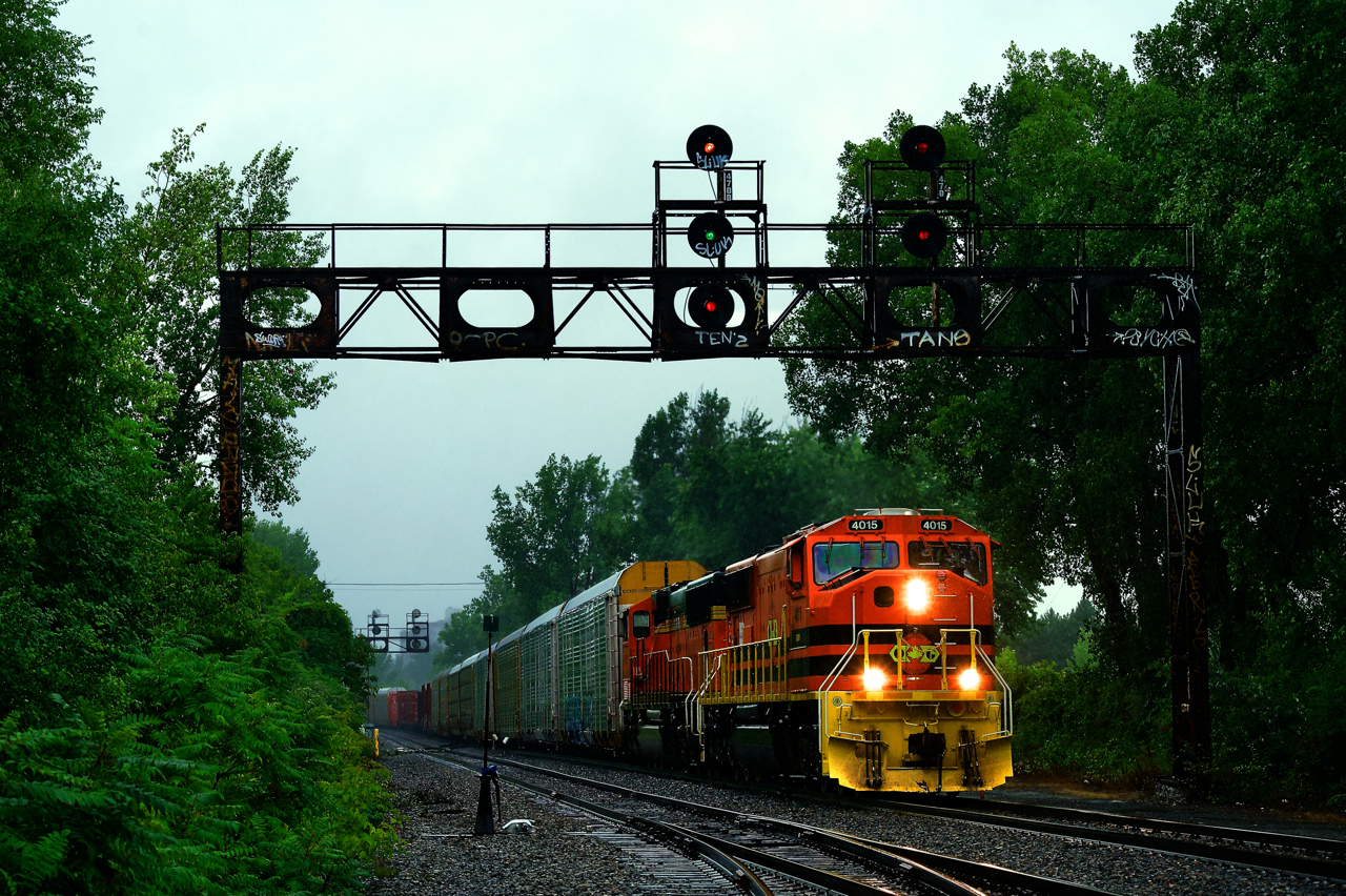 With the remnants of Hurricane Debby dumping what would total 153mm of rain on Montreal, QG 502 is leaving CPKC's St-Luc Yard on Friday. At left CPKC 133 lis lined to come back from the port. Power is ex-BNSF SD70MACs QGRY 4015 & QGRY 4021.