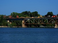 Rail train CN 907 has CN 5386 for power as it crosses the Richelieu River at Otterburn Park. It is lifting rail on the St-Hyacinthe Sub.