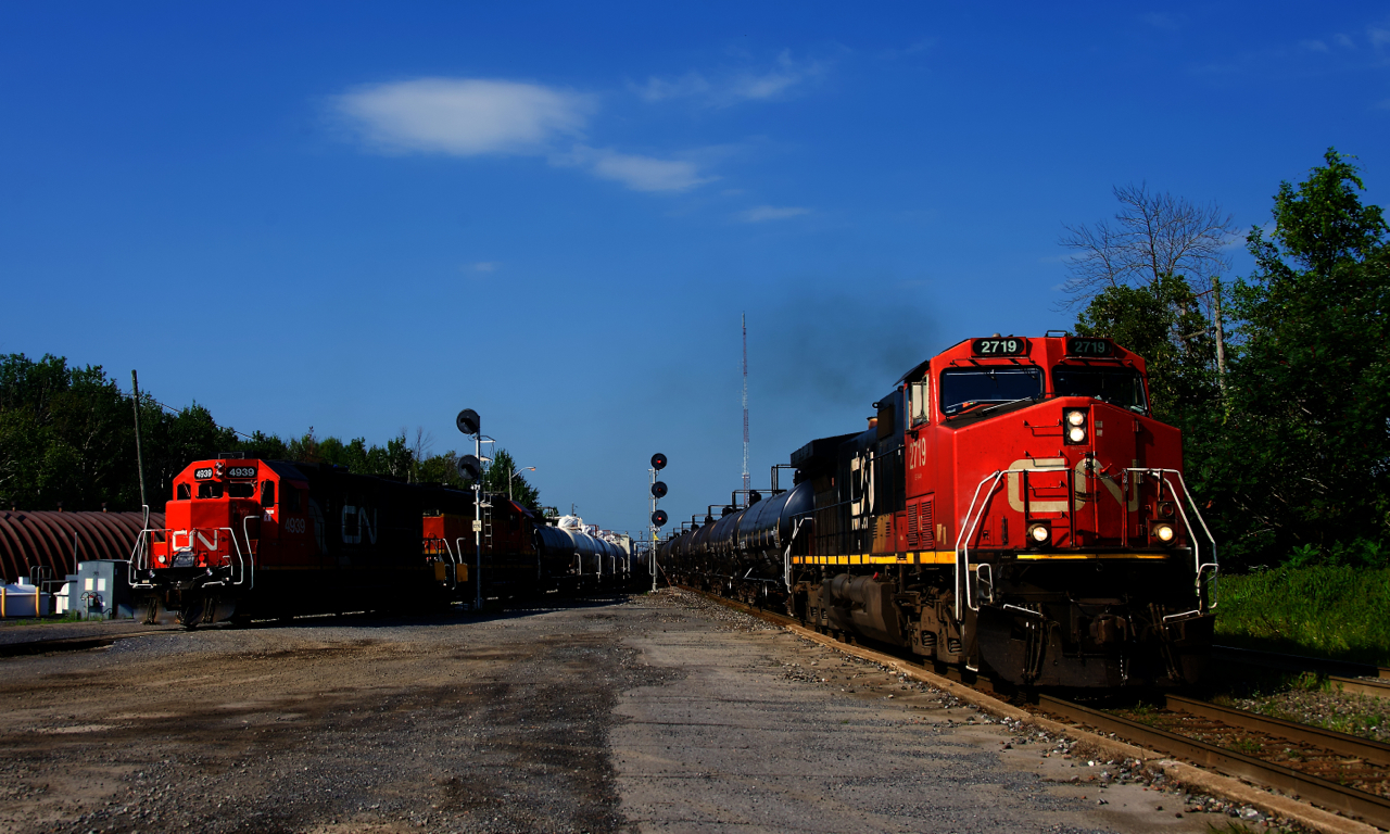 CN 538 is working the yard as CN 368 blasts by on the main line.