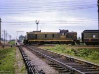 Train 82 from Grenville to Montreal behind ALCO RS3 3901 pounds the diamond with the St-Laurent Sub at E.J. Tower.  Per the CNRHA, this was one of two steam generator-equipped RS3s purchased for the Central Vermont in 1954 at CV 1859, 1860, later renumbered CV 3900, 3901 and finally transferred to the CNR in 1958.<br><br><i>Scan and editing by Jacob Patterson.</i>