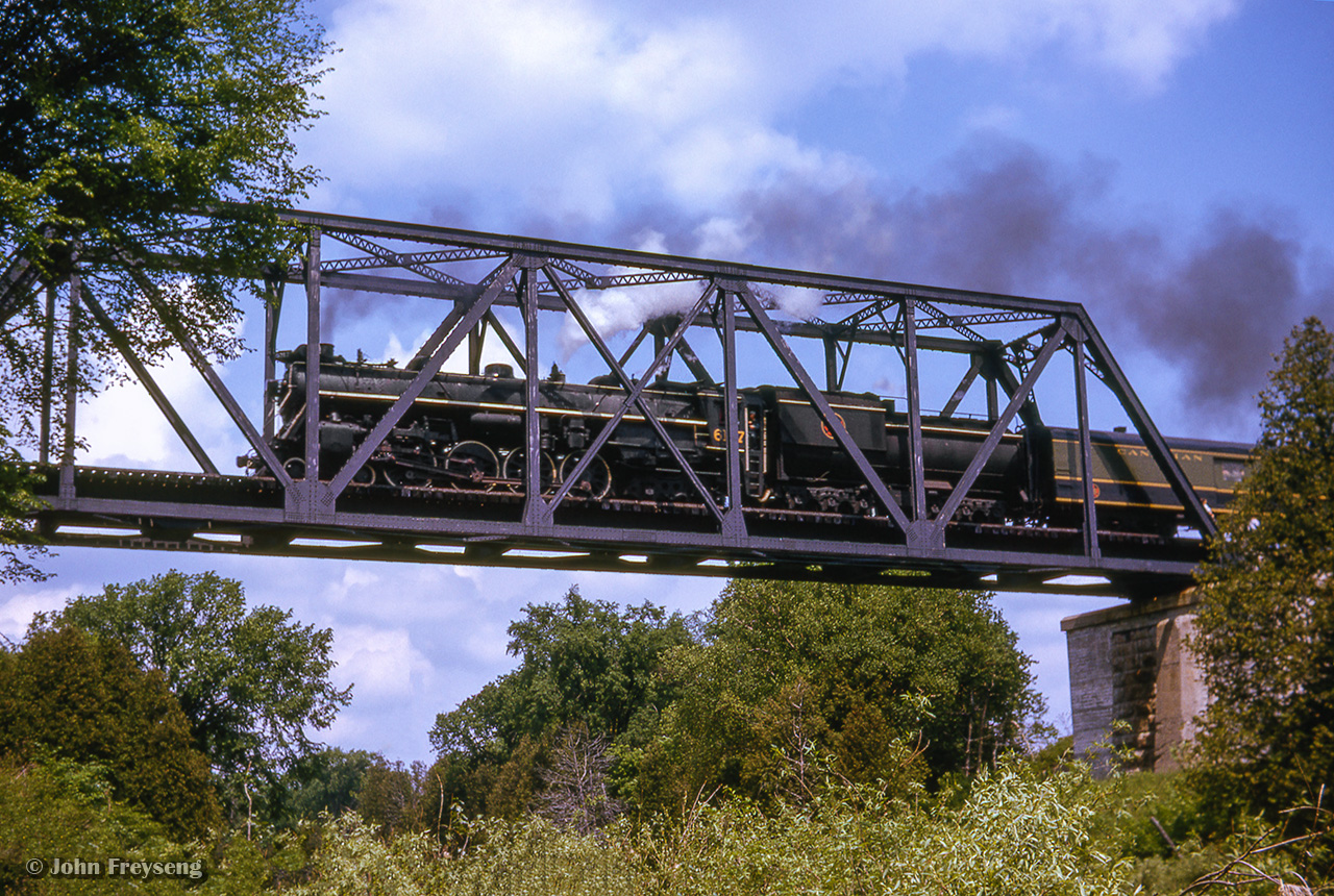 An Upper Canada Railway Society excursion behind CNR U-2-e 6167 is seen along the Fergus sub at Drayton, rumbling over the Conestogo River bridge. The train, carrying over 500 passengers, travelled from Toronto - Dundas - Lynden - Guelph - Palmerston - Stratford - Kitchener - Georgetown - Toronto.

Scan and editing by Jacob Patterson.