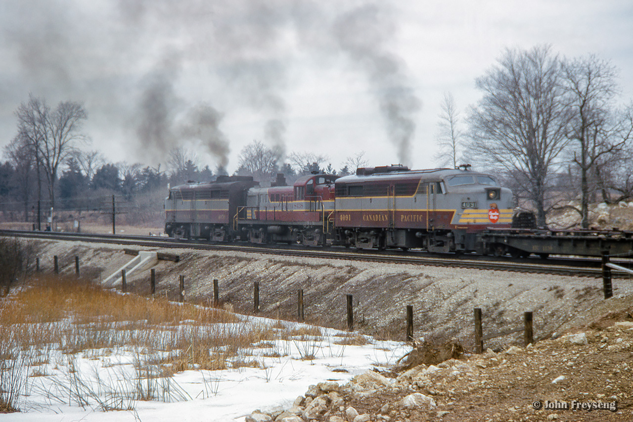 A going away shot of CP extra 4050 west just clear of First Line.  Moments before, the train had met extra 8027 west who will follow behind shortly.Scan and editing by Jacob Patterson.