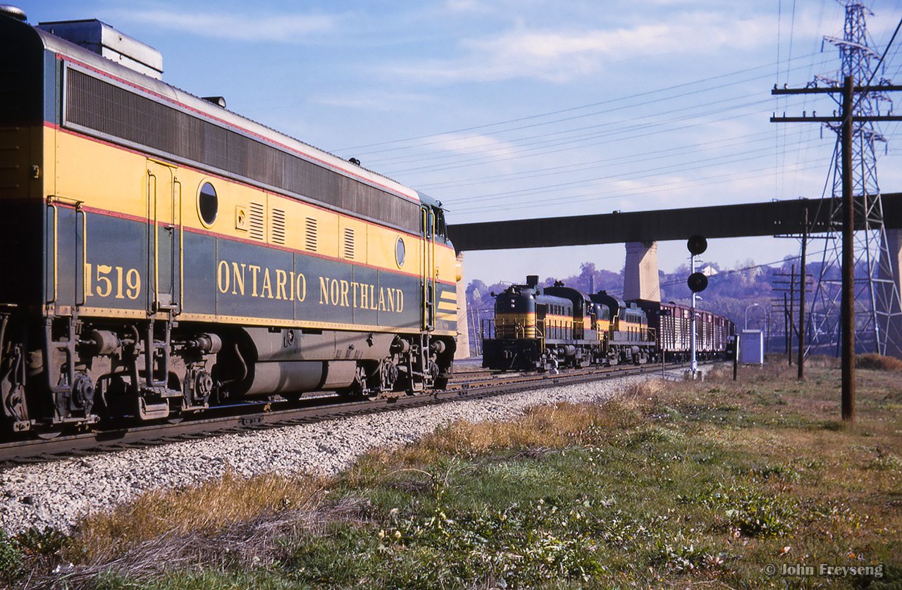 Toronto - North Bay train 459, led by F7s 1519, 1521, hold the main at the north end of Rosedale in the Don Valley while North Bay - Toronto train 452 behind RS3s 1300, 1311 takes the siding.Scan and editing by Jacob Patterson.