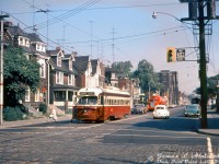 TTC PCC 4399 (A6-class built by CC&F in 1948) pauses southbound at the corner of Bathurst Street and Harbord Street drop off and pick up a passenger while on the Bathurst route. A red 1950's "needle-nose" Kenworth tanker truck in bright red paint follows in traffic, possibly operating for Texaco.<br><br><i>James L. Alain photo, Dan Dell'Unto collection slide.</i>