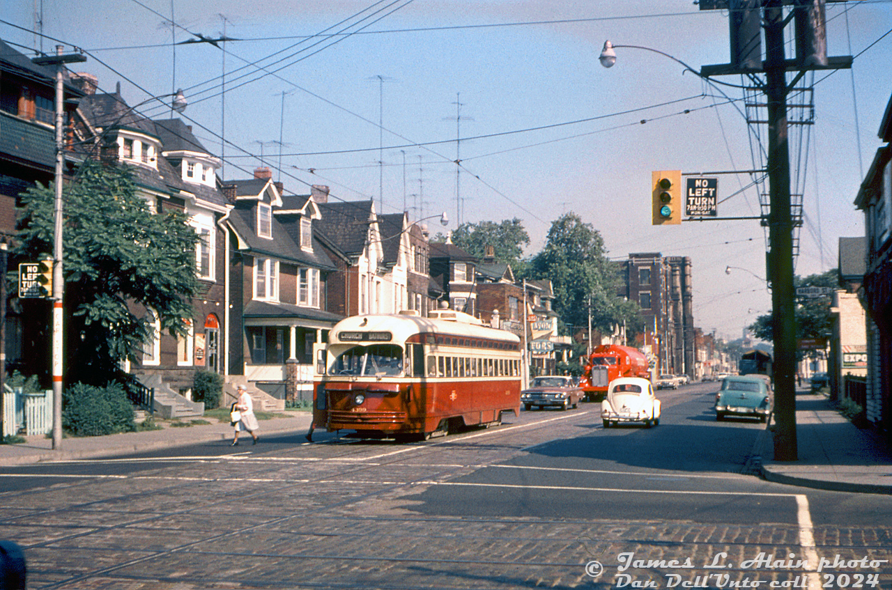 TTC PCC 4399 (A6-class built by CC&F in 1948) pauses southbound at the corner of Bathurst Street and Harbord Street drop off and pick up a passenger while on the Bathurst route. A red 1950's "needle-nose" Kenworth tanker truck in bright red paint follows in traffic, possibly operating for Texaco.James L. Alain photo, Dan Dell'Unto collection slide.