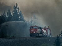 CN ES44AC 3836 shoves CN's "Trident" firefighting train eastward from Mile 231 on CN's Edson Sub to assist in battling the "North" fire of the Jasper Wildfire Complex.