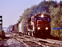 Former DT&I 417, repainted into CN/GTW 6417 still shows the crude plate job on its nose used to cover its former bell location from when it was built. Today the veteran GP40 works for RJ Corman, but back in 1997 it still plied CN rails as seen here heading eastbound under some not so great back lit conditions at Copetown West. 