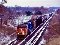 Back when it seemed GP40’s ruled the rails. Back in the mid CN and CP we’re both dealing with motive power shortages. Often leading and borrowing foreign units. Along with a group of NS C30-7’s, CN also borrowed a group of Conrail SD45-2. There was no mistaking the units considering they all had oversized fuel tanks. I believe some are still roaming NS rails today. Here a short eastbound with CN GP40-2W 9661 and borrowed Conrail SD45-2 6661 are heading towards Paris West after crossing the Nith River well in the distance. There is a bit of a clash of the seasons going on with snow and left over fall colours. 