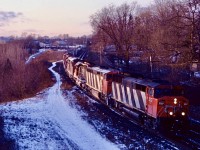 A long time favourite railfan town for me, Paris is on the top of my list of places I wish I could have seen in its prime railroad days. There was once several railroads that ran through town with CN also running two branchlines. One to Stratford and the other the Brantford by-pass. The years have claimed all the lines other then CN’s mainline. Sadly the beautiful station here was razed years ago as well. CN cowl units were definitely a highlight for me and are dearly missed in these GEVO days. I am standing just east of the onetime junction, near the station site as an eastbound, possibly 434 or 410 leans into the curve under dying light with several units now long off the roster.  Fond memories of a spot well grown it today. 