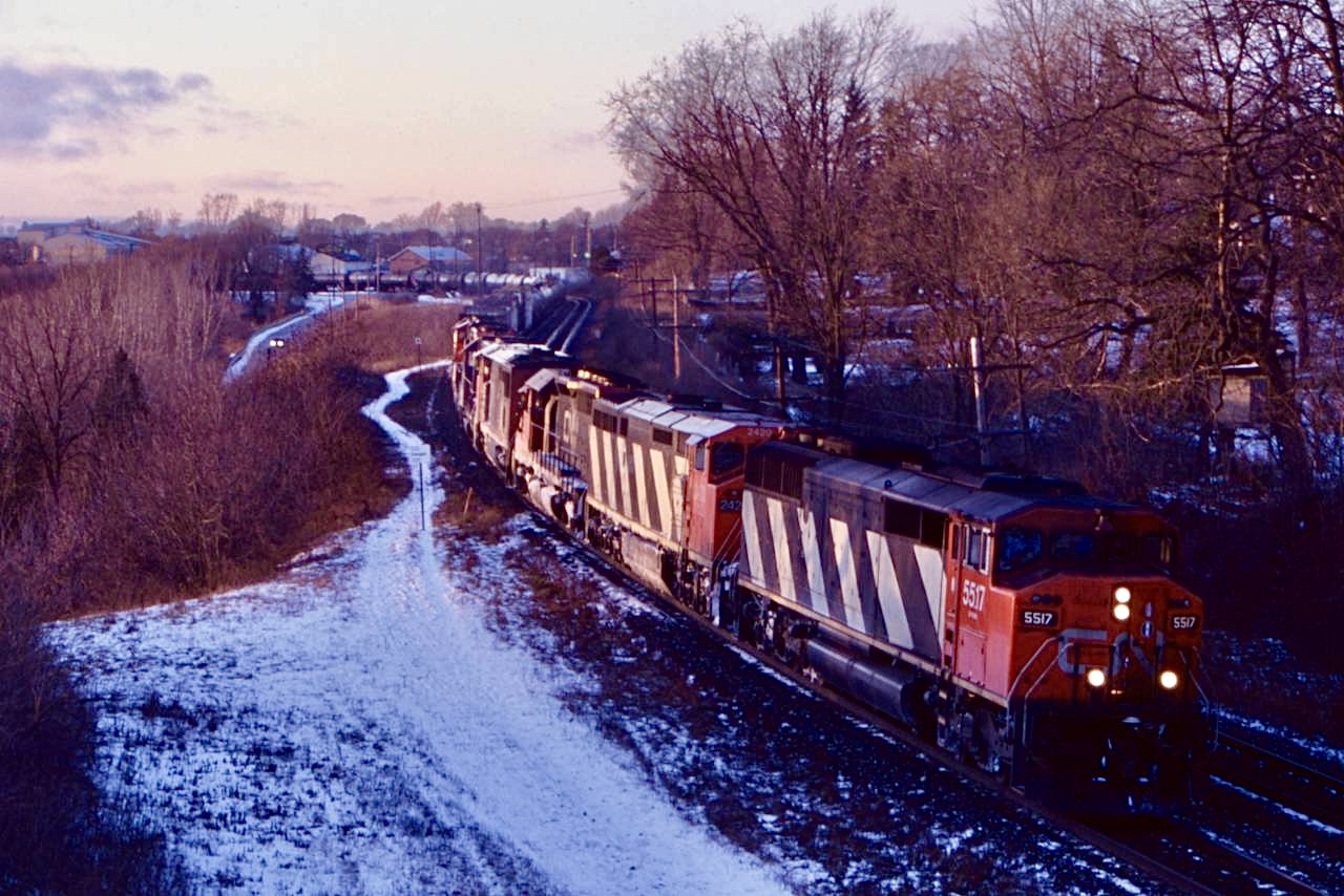 A long time favourite railfan town for me, Paris is on the top of my list of places I wish I could have seen in its prime railroad days. There was once several railroads that ran through town with CN also running two branchlines. One to Stratford and the other the Brantford by-pass. The years have claimed all the lines other then CN’s mainline. Sadly the beautiful station here was razed years ago as well. CN cowl units were definitely a highlight for me and are dearly missed in these GEVO days. I am standing just east of the onetime junction, near the station site as an eastbound, possibly 434 or 410 leans into the curve under dying light with several units now long off the roster.  Fond memories of a spot well grown it today.