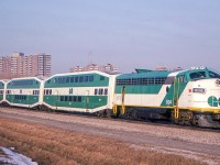 GO 904 and her train are in Scarborough, Ontario on March 24, 1982.