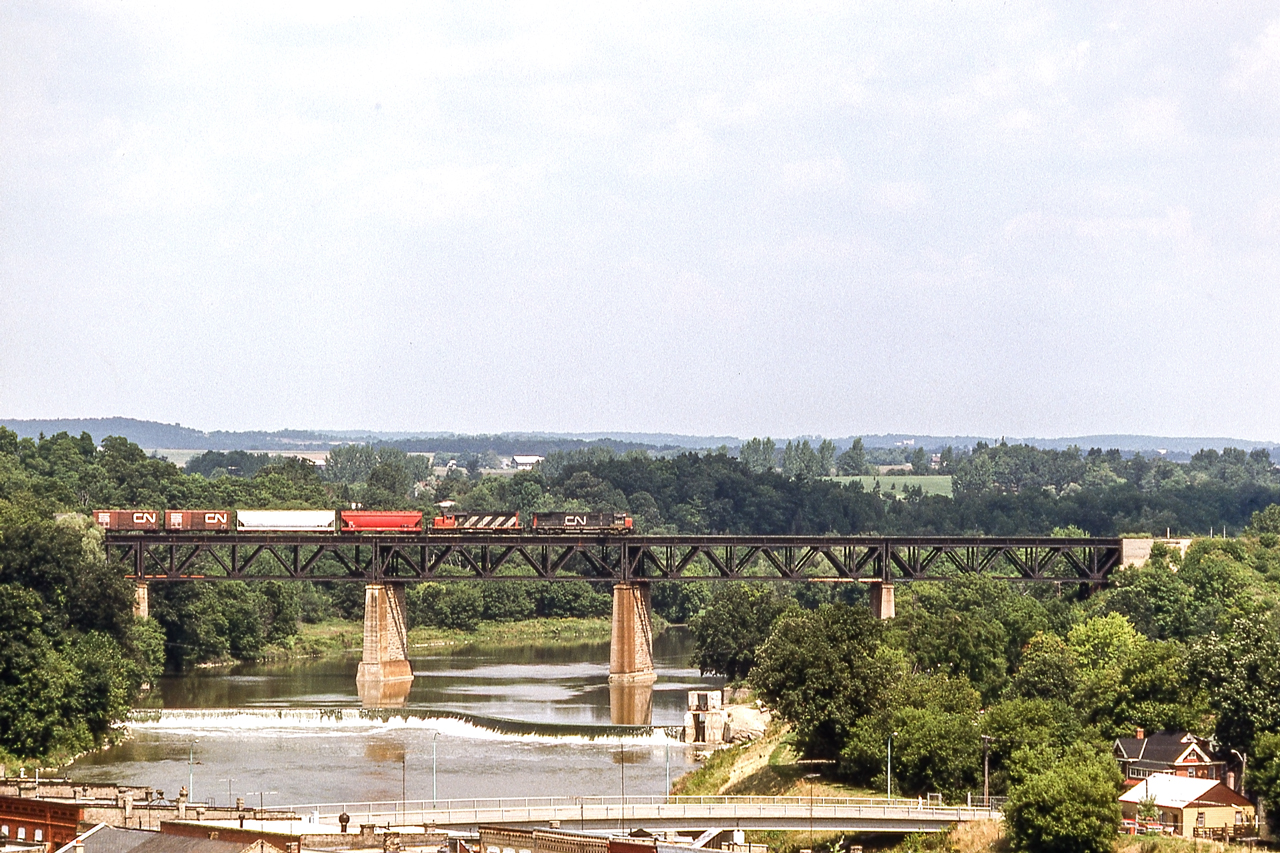 An eastbound CN freight is crossing the Grand River in Paris, Ontario on August 14, 1982.