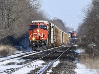 CN train 301 with CN 3161 in the lead overtakes train 385 at Stewardson Sideroad just east of Wanstead.