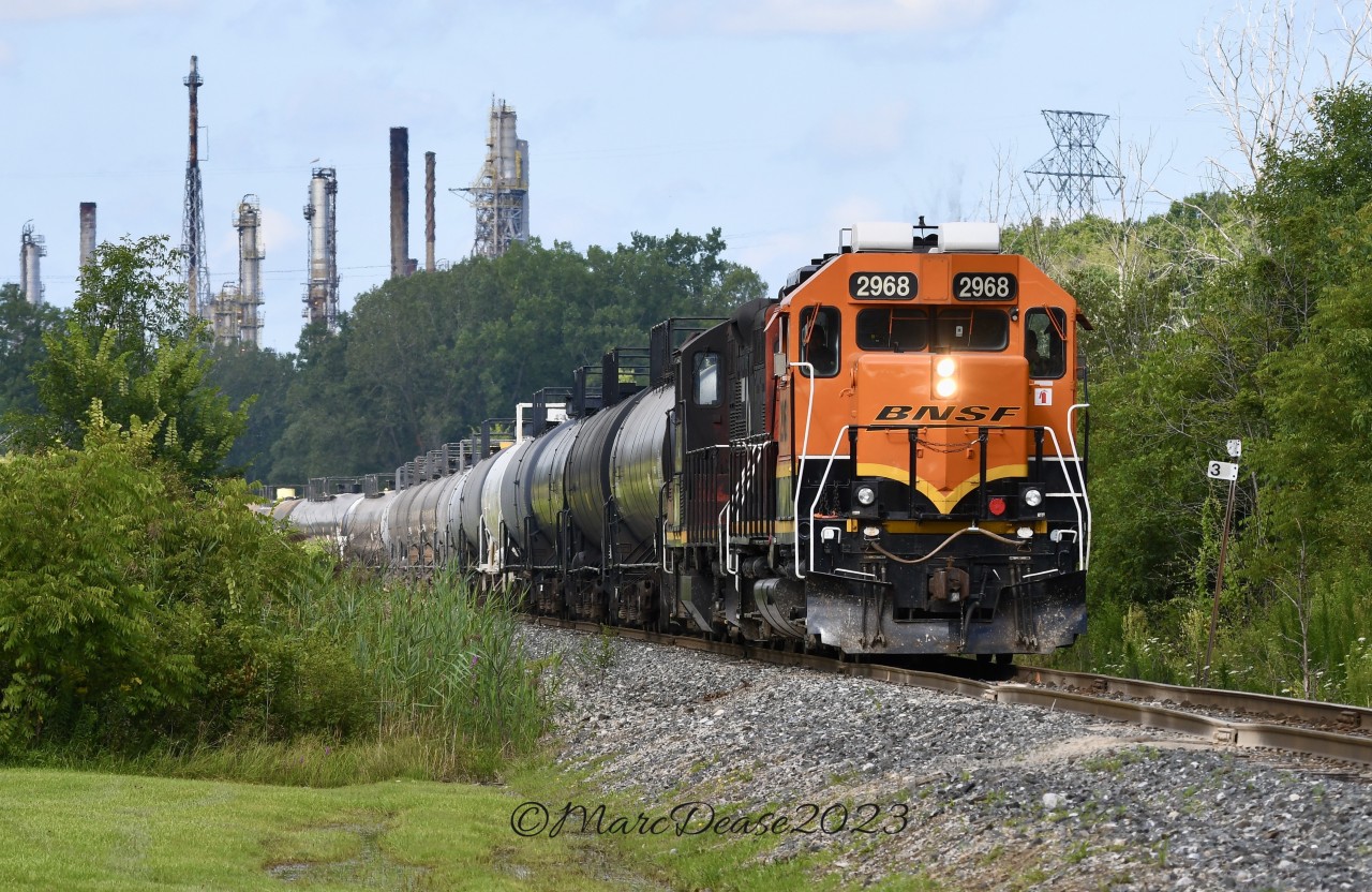 BNSF 2968 leads a cut of tankers back to CN Sarnia on the St. Clair Industrial Spur at Tashmoo Ave with the Suncor Refinery providing the back drop.