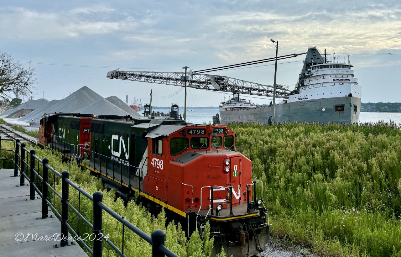 Having dropped a cut of cars at the Cargill Elevator, CN 4798 with CN 4770 head back to CN Sarnia yard along the Point Edward Spur while the 71 year old, 1953 built SAGINAW shifts unloading positions at the City Dock in Sarnia, ON.