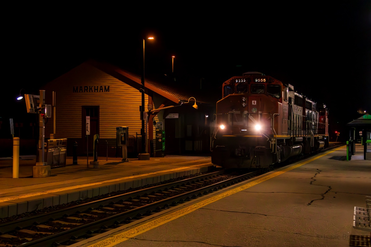 CN in Markham, a reunion 10 years in the making. 
After the YDHR shut its doors for the final time, ONR wanted their GP9 back and the crew of CN L546 was tasked with retrieving it from Lincolnville. CN 9555 and CN 9450 run up the Metrolinx Uxbridge sub light power to grab it, marking the first CN units to pass the historical Markham train station in 10 years, as far as I can tell. In 2014, CN ran a few work trains on the Uxbridge but since, only GO and ONR 1603 have passed the station. It's the wee hours of May 26th, nearly 01h30, yet nearly 10 railfans are out chasing this rare movement.