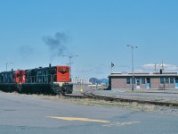 <br>
<br>
Narrow Gauge Time.
<br>
<br>
The Rock style.
<br>
<br>
Terra Transport mixed trains #207 and #208 operated  St.John's -  Argentia  every Monday, Wednesday, Friday 
<br>
<br>
And your subsidy operated 207 and 208  while the CNR Marine ferry  M V Ambrose Shea  (1967 to 1989) arrived / departed  Argentia  on Tuesday, Thursday, Saturday –  no surprise the passenger counts on 207 & 208 were light.
<br>
<br>
Completing its turn on the wye, TT #805 & 800 positions #208 (in all CN livery)  for departure from Argentia August 8, 1982 Kodachrome by S.Danko
<br>
<br>
Noteworthy: The importance of Argentia and the railway –  to the security of  North America is overlooked / forgotten (per Wikipedia): 
<br>
<br>
December 28, 1940: the Newfoundland Commissioner of Public Works conveys Argentia lands to the USA for military purposes. 
<br>
<br>
February 13, 1941: the US flag raised when US Marines occupy Argentia, Newfoundland
<br>
<br>
July 15, 1941: the new US Naval Operating Base commissioned ( the US Navy extends the CNR  Placentia branch to service the base)
<br>
<br>
August 7, 1941, the heavy cruiser USS Augusta (CA-31) carrying U.S. President Franklin D. Roosevelt arrived at an anchorage outside Argentia near Ship Harbour. Roosevelt inspected the base construction progress and did some fishing from Augusta (the largest fishing boat ever?) over the next two days. 
<br>
<br>
August 9, 1941: Augusta was joined by the British warship HMS Prince of Wales carrying British Prime Minister Winston Churchill .  While in the Ship Harbour anchorage from August 9–12, the chiefs of staff of Britain and the US met to discuss the war strategies and logistics once the US joined the war. 
<br>
<br>
1942: US Army base and US Air Force base, open and by 1943 up to 10,000 military personal assigned to the bases.
<br>
<br>
1944: the captured German weather ship, the Externstein, was brought into Argentia by Commodore Rose
 <br>
<br>
1945: Two German submarines ( real  U – boats ) captured in Europe stop at Argentia en route to the United States. The U-Boats, sailed on the surface by prize crews, put in for fuel, repairs, provisions, and stores.
<br>
<br>
1949:  Newfoundland (and Labrador ) join the Canadian Confederation 
<br>
<br>
1967: the new Argentia ferry terminal opens, built and operated by the Canadian National Railways and seasonally served by the CN Marine ferry M V Ambrose Shea. 
<br>
<br>
1994: the  US Naval Operating Base officially closes (yes, in 1994) – at the time of this 1982 Kodachrome exposure there was no noticeable naval activity – and the lands formally conveyed to the Government of Canada.
<br>
<br>
 More #208
<br>
<br>
     <a href="http://www.railpictures.ca/?attachment_id=  24426 ">  flag stop  </a>
<br>
<br>
sdfourty