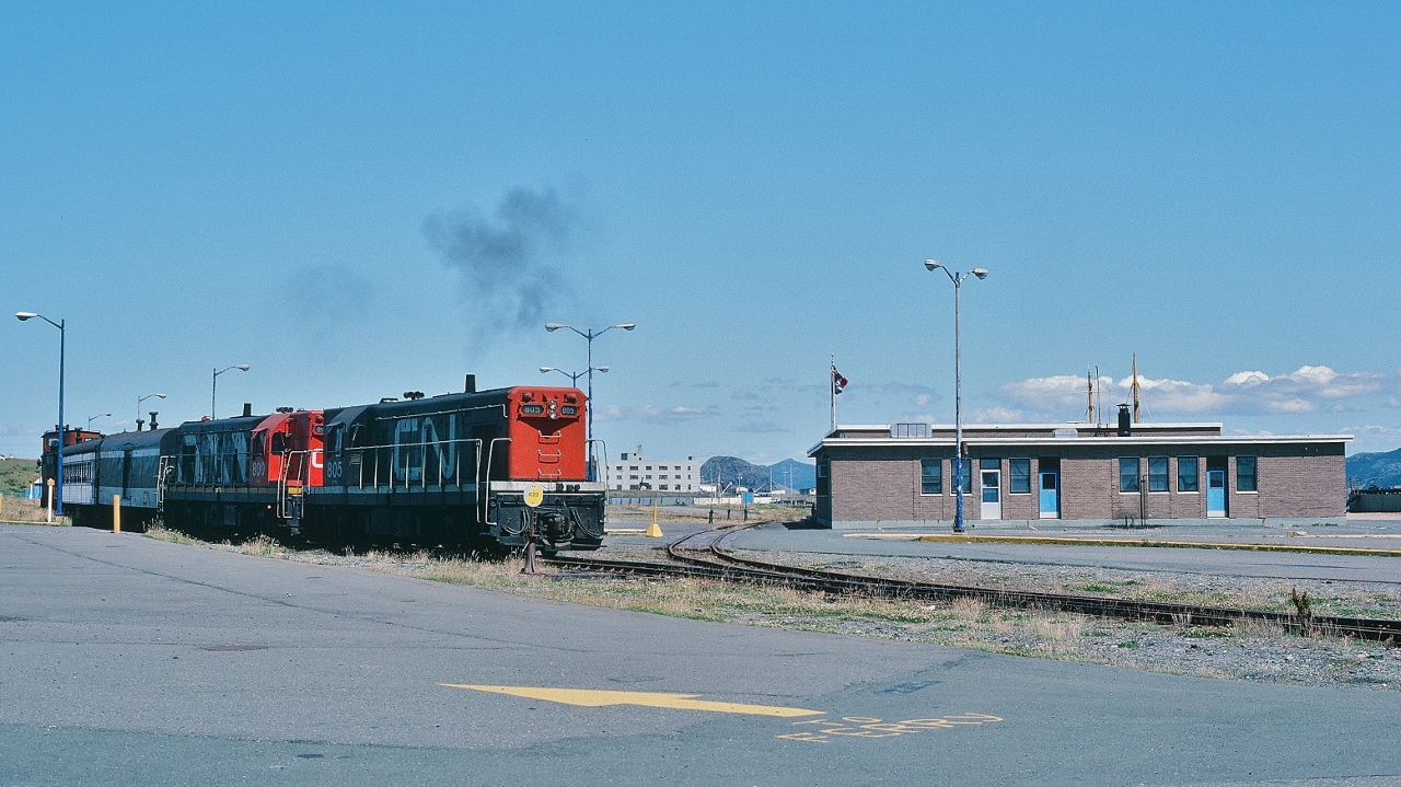 Narrow Gauge Time.


The Rock style.


Terra Transport mixed trains #207 and #208 operated  St.John's -  Argentia  every Monday, Wednesday, Friday 


And your subsidy operated 207 and 208  while the CNR Marine ferry  M V Ambrose Shea  (1967 to 1989) arrived / departed  Argentia  on Tuesday, Thursday, Saturday –  no surprise the passenger counts on 207 & 208 were light.


Completing its turn on the wye, TT #805 & 800 positions #208 (in all CN livery)  for departure from Argentia August 8, 1982 Kodachrome by S.Danko


Noteworthy: The importance of Argentia and the railway –  to the security of  North America is overlooked / forgotten (per Wikipedia): 


December 28, 1940: the Newfoundland Commissioner of Public Works conveys Argentia lands to the USA for military purposes. 


February 13, 1941: the US flag raised when US Marines occupy Argentia, Newfoundland


July 15, 1941: the new US Naval Operating Base commissioned ( the US Navy extends the CNR  Placentia branch to service the base)


August 7, 1941, the heavy cruiser USS Augusta (CA-31) carrying U.S. President Franklin D. Roosevelt arrived at an anchorage outside Argentia near Ship Harbour. Roosevelt inspected the base construction progress and did some fishing from Augusta (the largest fishing boat ever?) over the next two days. 


August 9, 1941: Augusta was joined by the British warship HMS Prince of Wales carrying British Prime Minister Winston Churchill .  While in the Ship Harbour anchorage from August 9–12, the chiefs of staff of Britain and the US met to discuss the war strategies and logistics once the US joined the war. 


1942: US Army base and US Air Force base, open and by 1943 up to 10,000 military personal assigned to the bases.


1944: the captured German weather ship, the Externstein, was brought into Argentia by Commodore Rose
 

1945: Two German submarines ( real  U – boats ) captured in Europe stop at Argentia en route to the United States. The U-Boats, sailed on the surface by prize crews, put in for fuel, repairs, provisions, and stores.


1949:  Newfoundland (and Labrador ) join the Canadian Confederation 


1967: the new Argentia ferry terminal opens, built and operated by the Canadian National Railways and seasonally served by the CN Marine ferry M V Ambrose Shea. 


1994: the  US Naval Operating Base officially closes (yes, in 1994) – at the time of this 1982 Kodachrome exposure there was no noticeable naval activity – and the lands formally conveyed to the Government of Canada.


 More #208


       flag stop  


sdfourty