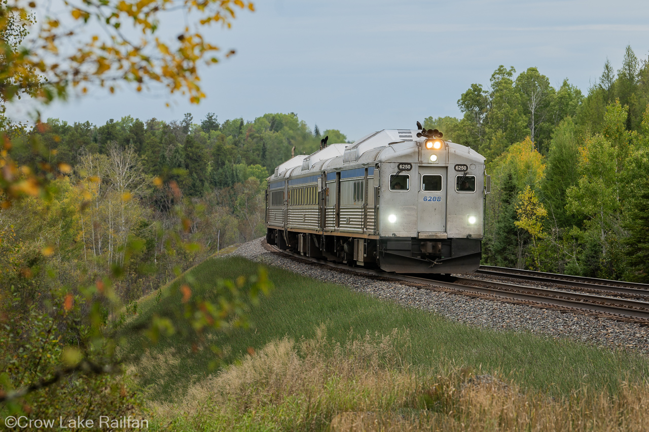 The almost daily flagstop run of Vias Budd cars highballs past Devon on the Nemegos sub returning from White River to Sudbury.