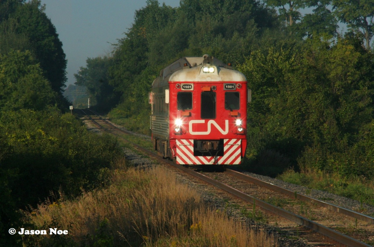 After having laid over in Kitchener yard for the night, CN test RDC 1501 had an early morning departure testing the rails to Toronto, Ontario the following day. The RDC is viewed approaching the Woolwich-Guelph Townline crossing, west of Guelph as it heads to Silver (Georgetown) on the Guelph Subdivision.