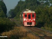 After having laid over in Kitchener yard for the night, CN test RDC 1501 had an early morning departure testing the rails to Toronto, Ontario the following day. The RDC is viewed approaching the Woolwich-Guelph Townline crossing, west of Guelph as it heads to Silver (Georgetown) on the Guelph Subdivision.