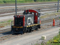 CN SW1200RSm 7311 is viewed pausing near the Highway #7 overpass at MacMillan Yard in Vaughn, Ontario. The crew had just re-aligned the switch and were preparing to head back into the yard after switching the newly built fuel transloading facility. 