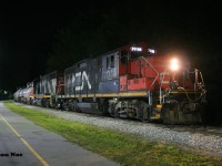 CN L566 with GP9RM 7038 and GP38-2 4716 and are viewed waiting near Roger Street in Waterloo, Ontario for permission to proceed north on the ION portion of the Waterloo Spur to Elmira.