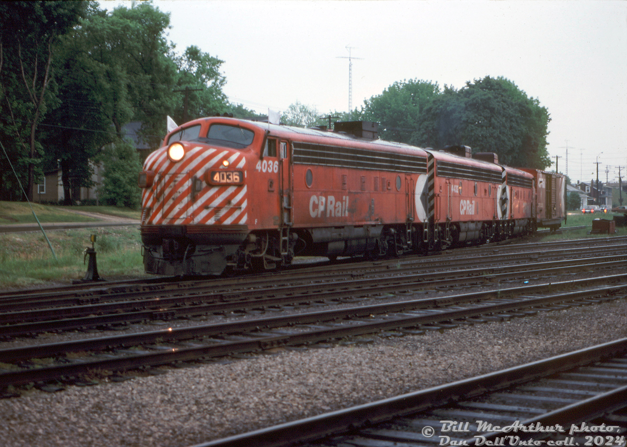 A matched A-B-A set of CP Rail F-units (FP7 4036, F7B 4432, and FP7 4063) leave their westbound train on the mainline as they switch the west end of Galt Yard on a gloomy day.

By this point in time, the Alco/MLW and FM/CLC fleets of cowl units had been retired, leaving only the GMD fleet, which would soldier on until most of the passenger F-unit fleet was sold to VIA in 1978, and most of the remaining F-units in freight service were retired in 1982. 

Bill McArthur photo, Dan Dell'Unto collection slide.