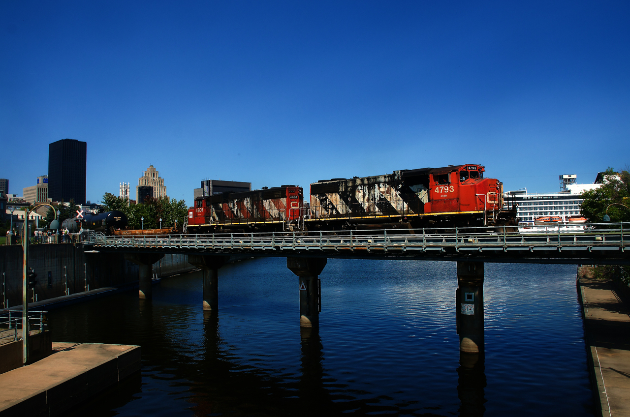 CN 500 is leaving the Port of Montreal, with a cruise ship docked in the background.