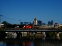 CN 2755 has a spraypainted # on the side and 'Citirail' crossed out on the long hood as it leads CN 100 over the Lachine Canal. It is heading to the Port of Montreal with a 3,800 foot long train after setting off cars at Taschereau Yard.