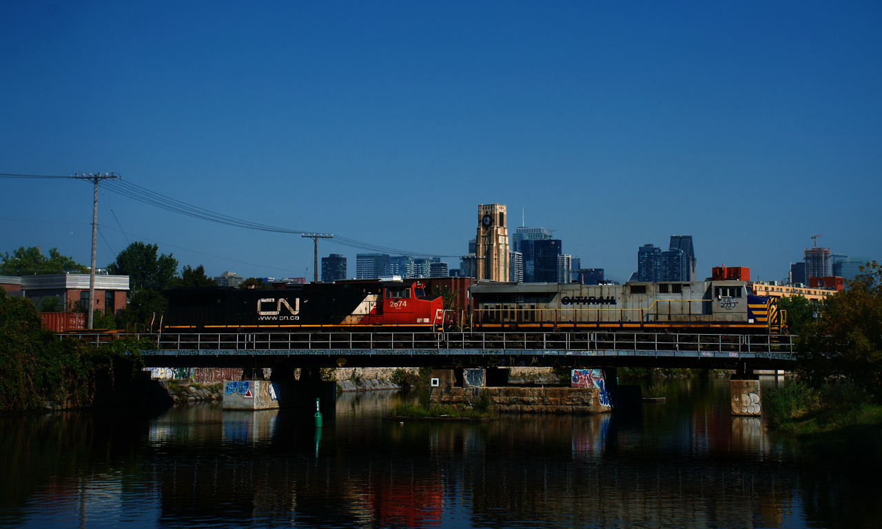 CN 2755 has a spraypainted # on the side and 'Citirail' crossed out on the long hood as it leads CN 100 over the Lachine Canal. It is heading to the Port of Montreal with a 3,800 foot long train after setting off cars at Taschereau Yard.