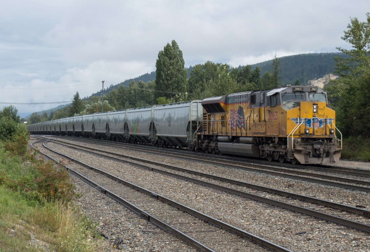 UP 3063 brings up the rear of CPKC 301 as it blasts through Golden British Columbia.