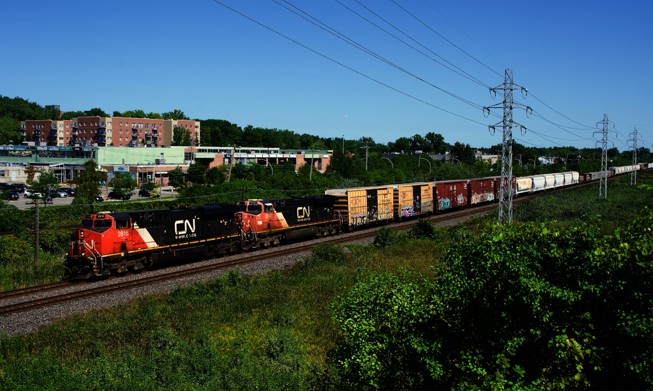 CN 369 has an ES44AC and a faded ES44DC for power as it heads west.