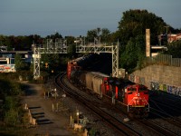 It's about an hour after sunrise as CN 322 heads east with two SD70M-2s up front and a Dash9 mid-train. After setting off cars at Taschereau Yard, it is heading to its terminus of Southwark Yard.