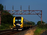 VIA 44 for Ottawa has the specially painted Lumi trainset as it passes under an out of use signal gantry.