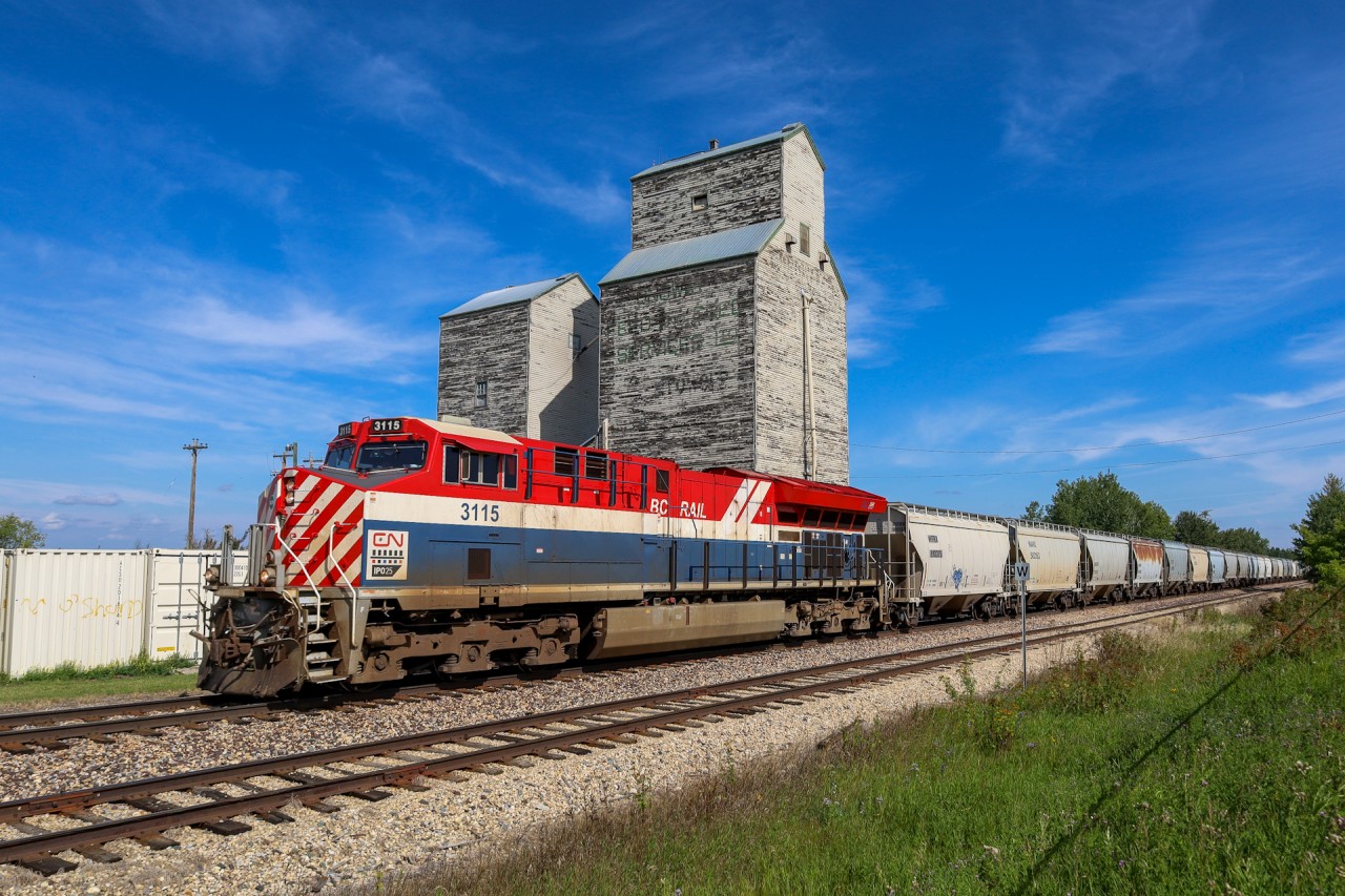 The BC Rail Heritage Unit cruises through Onoway with 101 sand loads for Benbow, Alberta