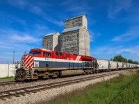 The BC Rail Heritage Unit cruises through Onoway with 101 sand loads for Benbow, Alberta 