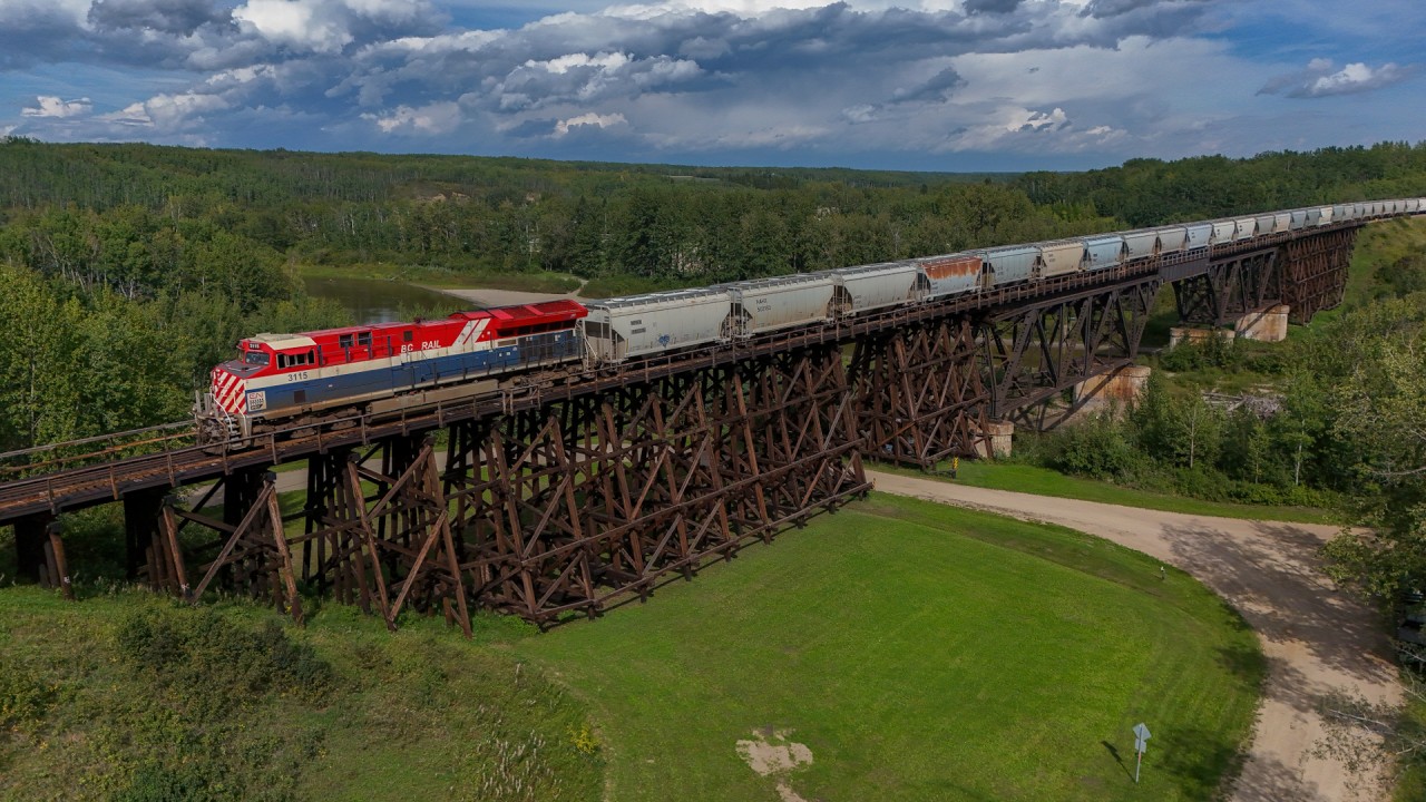 S 76381 31 soars over the Pembina River in Sangudo, Alberta with the BC Rail heritage unit leading.