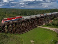 S 76381 31 soars over the Pembina River in Sangudo, Alberta with the BC Rail heritage unit leading.  