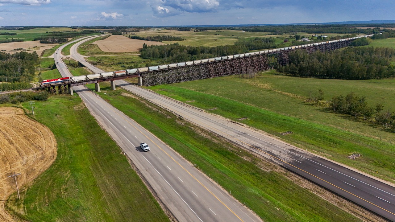 The BC Rail heritage unit, CN 3115 brings 101 sand loads across the 2584 foot long trestle at Rochfort Bridge.