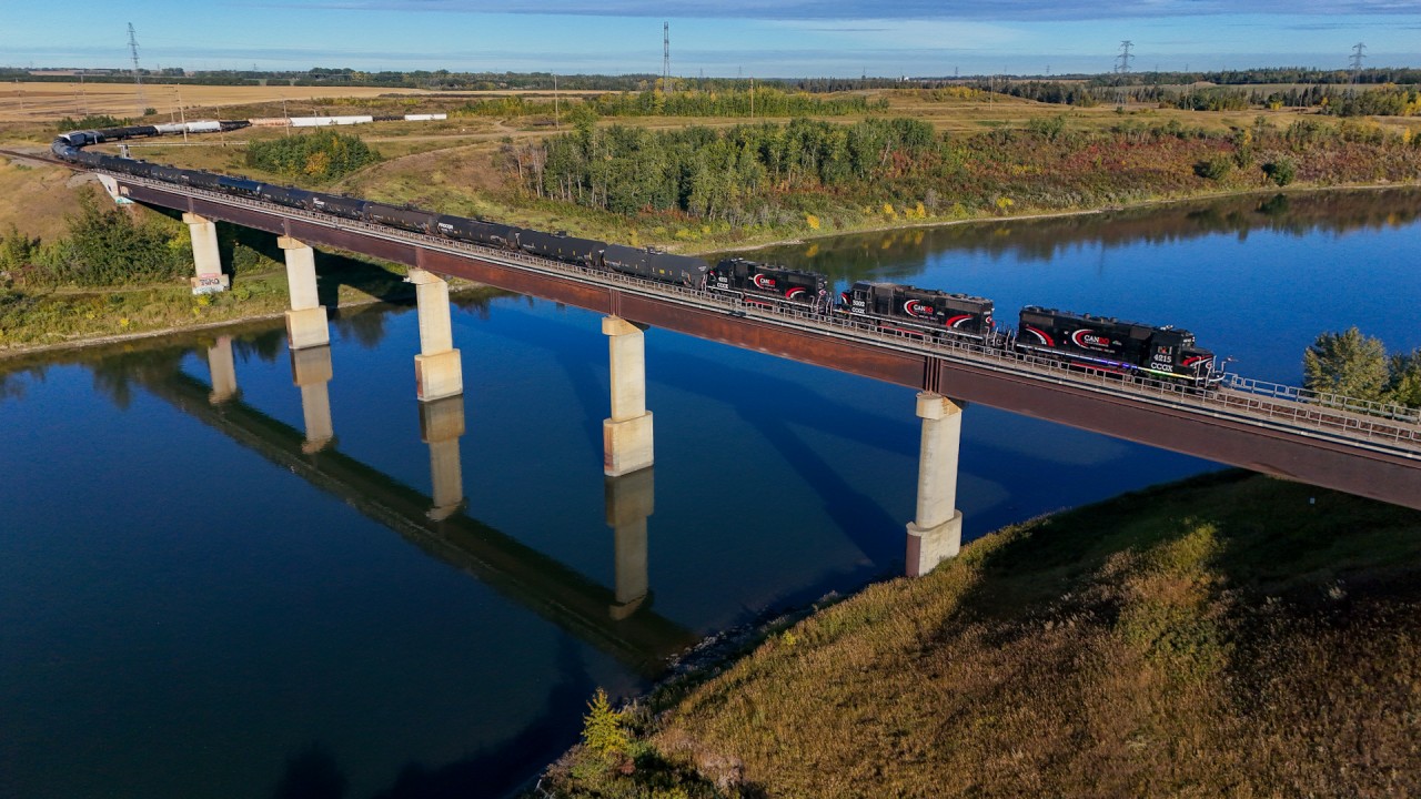 The morning Cando job from the Beamer Industrial spur rolls across the North Saskatchewan River on a beautiful summer morning. Power this day was CCGX 4215, CCGX 5202 and CCGX 4214