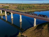 The morning Cando job from the Beamer Industrial spur rolls across the North Saskatchewan River on a beautiful summer morning. Power this day was CCGX 4215, CCGX 5202 and CCGX 4214