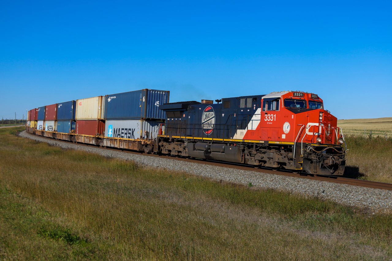 CN Q 18051 27 highballs through Greenshields after a quick crew change in Wainwright and a meet with Q 18521 27 on the double track.  CN 3331  is one of two units featuring logos from CN’s past;  The round Canadian National logo is a modification of the Canadian Northern (CNoR) logo and was utilized for a few years after CN’s inception in 1919.  Both retro logo units CN 3309 and CN 3331, typically operate in the Chicago to New Orleans corridor, staying close to Homewood for executive train service and on rare occasion escape that corridor in freight service.  And yes, the “CNoR heritage” unit is flying down the old Grand Trunk Pacific mainline - home rails for the Canadian Northern are about 45 minutes north of this location on the Blackfoot and Vegreville Subs!