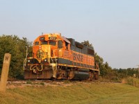 A BNSF unit is heading towards Blenheim, ON on a CN local, returning horsepower hours to CN. They would lift 15 cars and head back to Chatham after. Noted in the photo is an old whistle sign that is still barely standing.