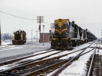 A pair of pups wait on the Uxbridge Sub with a short local while Extra 3637 west flies by on the Oshawa Sub mainline for Mimico.  The new Scarborough Junction station can be seen beyond the power, built in 1964 to replace the second station, which burnt down in 1960.  This structure stood until the Midland Avenue grade separation project in 1977-78.<br><br><i>Scan and editing by Jacob Patterson.</i>